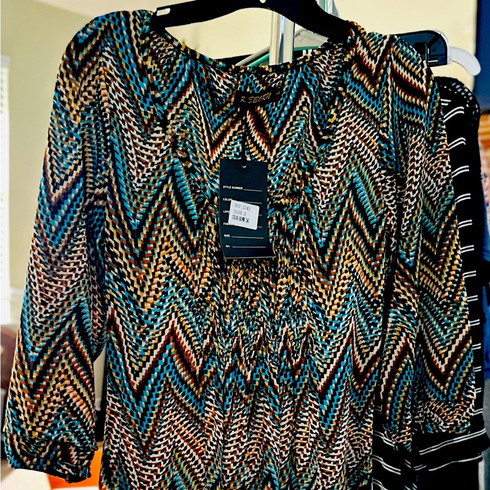 Smocked upper bodice, knee length, elbow sleeved dress.